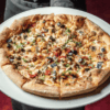 Why is it worth trying Wolfgang Puck’s pizzas in San Fernando Valley or Los Angeles?